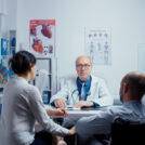 In modern clinic for disabled and handicapped recovery, young man in wheelchair is seeking consultation and treatment. Dsabled disability handicapped person treatment in modern private hospital or clinic. Medicine and health care system